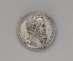 Silver portrait medal of the Duke of Alba.  He is shown in profile on his right side.  He wears…