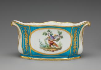 Porcelain oval dish in blue, white, and gold with birds