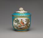 Porcelain sugar bowl in blue and gold with an image of a bird in a tree