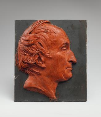 Wax portrait of a man in profile to the right