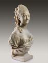 Alternate view of a marble bust of Madame His.  She has long curly hair that is elaborately pin…