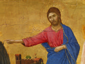 close-up of a tempera painting of Christ, followed by two angels, extending his right arm towar…