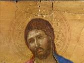 close-up of a tempera painting of Christ, followed by two angels, extending his right arm towar…