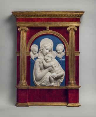 A white ceramic relief of the Madonna of the Impruneta.  The Madonna is holding an infant Jesus…