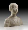 Alternate view of a marble bust of the Beatrice of Aragon.  Her hair is neatly wrapped behind h…