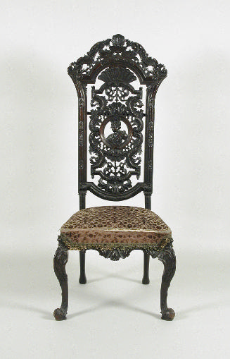 Alternate view of walnut chair with openwork back and upholstered seat