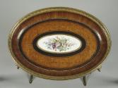Detail of table top with marquetry of several woods and Sevres porcelain plaque in the center