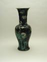 Tall porcelain vase with black ground and floral and vegetal designs