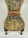 Detail of seat of chair, showing birds and flowers