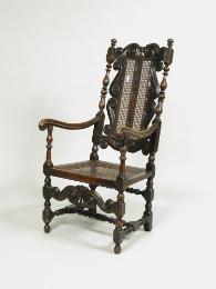 Walnut armchair with scrollwork decoration and woven seat