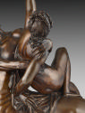 Close-up of a bronze sculpture of a woman struggling against a centaur