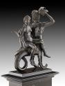 A bronze sculpture of Triton and Nereid.  Triton is depicted as half man, half fish.  The nerei…