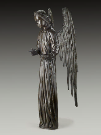 A bronze sculpture of an angel.  The angel stands upright with wings stretched behind it, the r…