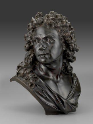 Bronze sculpture of Robert de Cotte.  The bust has a long curly wig and his head is turned to h…