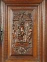 Detail of walnut and pine cabinet with relief carving of female figure between two mythological…