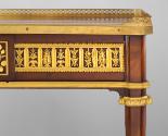 Gilt-bronze onrnamental band on side of writing table