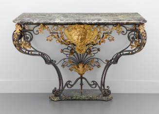 Console Table of Forged Iron with a center gilded mask and a marble top