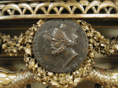 Detail of medal with two profiles, including a man in a turban, on a Small Console Table with S…