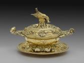 Gilt silver soup tureen with inverted dead pheasant and intricate design on silver platter