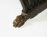 Detail of foot of walnut folding armchair, in the form of a paw