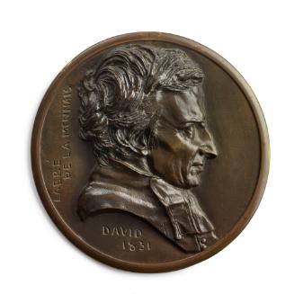 A bronze circular medal.  The sitter is L'Abbé de Lamennais, he is seen in profile from his rig…