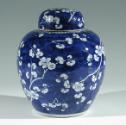 Single blue porcelain covered jar decorated with white floral decorations.