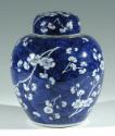 Single blue porcelain covered jars decorated with white floral decorations.