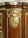 Detail of gilt bronze mask of man with beard on commode