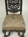 Detail of embroidered seat, showing flowers, fruit, and insects 