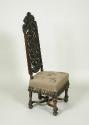 Walnut chair with openwork back and embroidered seat showing flowers, fruit, and insects