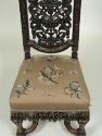 Detail of embroidered seat, showing flowers, fruit, and insects