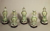 Group of five green porcelain jars with floral and vegetal designs