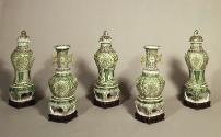 Group of five green porcelain jars with floral and vegetal designs