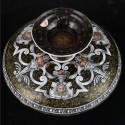 View of underside of cup showing lavish enameled decoration with sheathed figures and marks und…