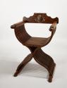 Walnut folding armchair with central crest