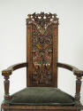 Armchair with Grotesque Reliefs and green cushion, view of seat back carving