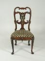 Front view of walnut frame chair with crest and upholstered seat