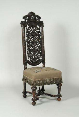 Walnut chair with openwork back and embroidered seat showing flowers, fruit, and insects