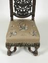 Detail of embroidered seat, showing flowers, fruit, and insects