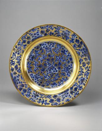 Gilt plate with blue floral motif