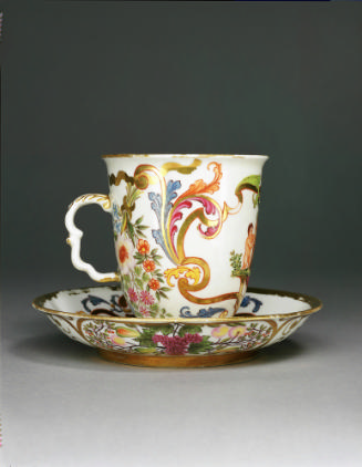 Teacup on a saucer with floral motif