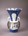 Second vase of a pair in white porcelain with blue glaze. The bottom half with a cage structure…