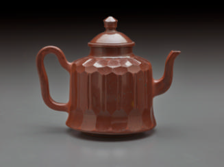 Red stoneware teapot with cover.