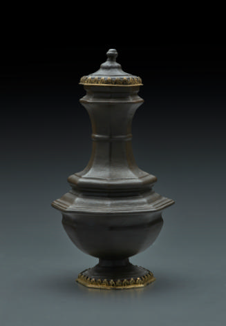 Octagonal vase with mounted foot and cover.