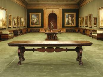 Walnut table with supports in the form of scrolls and lion's-paw feet