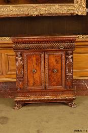 Wood cabinet with relief carving showing figural decoration