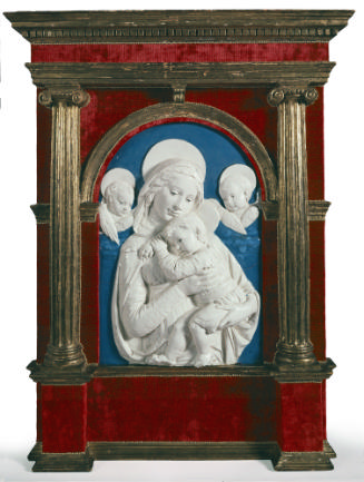 A white ceramic relief of the Madonna of the Impruneta.  The Madonna is holding an infant Jesus…