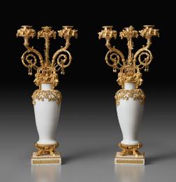 Two white porcelain candelabra with ornate gilt bronze decoration