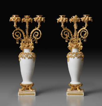 Two white porcelain candelabra with ornate gilt bronze decoration