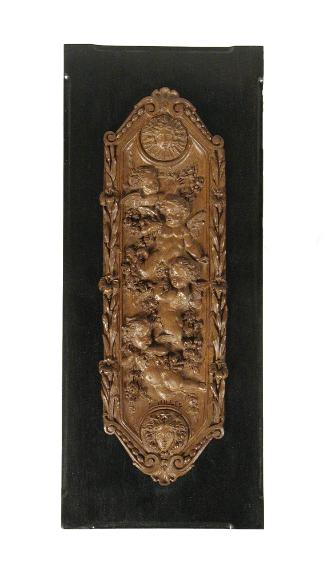 Carved walnut architectural ornament (guilloche) with putti decoration